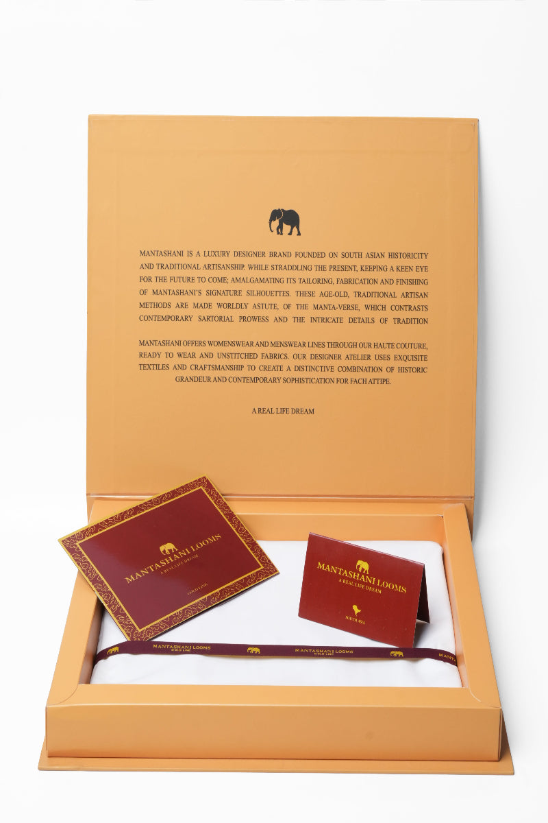 Mansarovar Lodges branded items including a card and a band in an open box on a white background