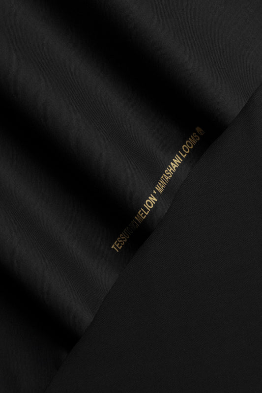 Close-up of black fabric with a visible brand logo.