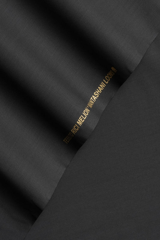 Black fabric with a brand label on a black background
